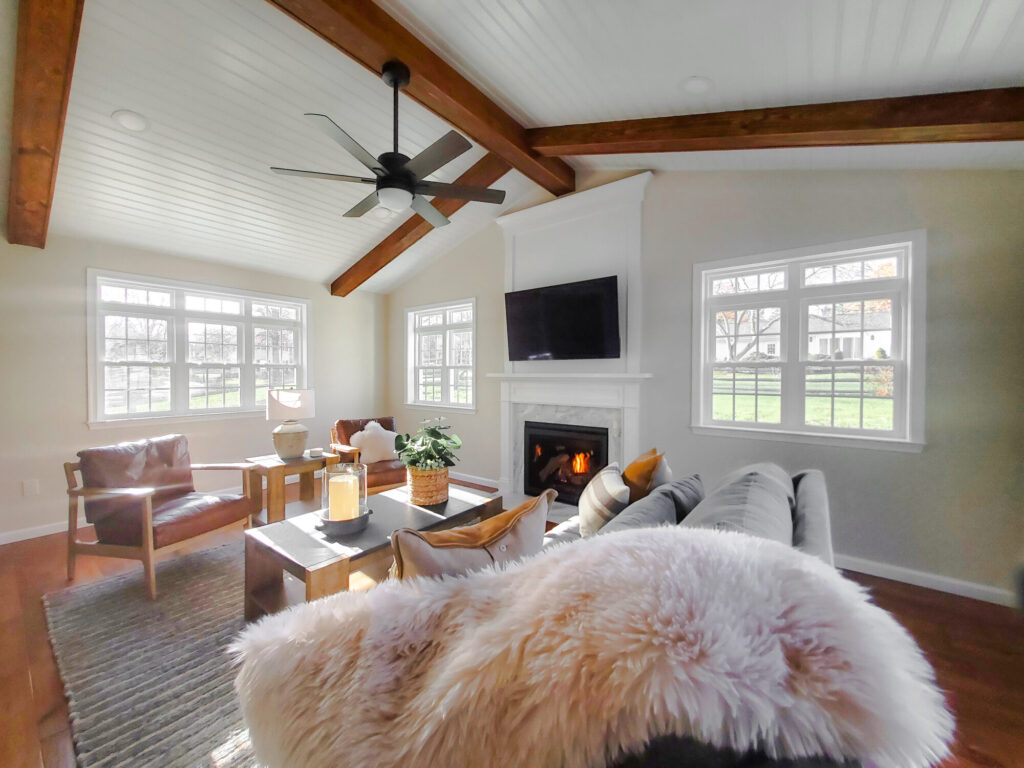 A beautifully styled and cozy addition, complete with fireplace, replacement windows and exposed beams