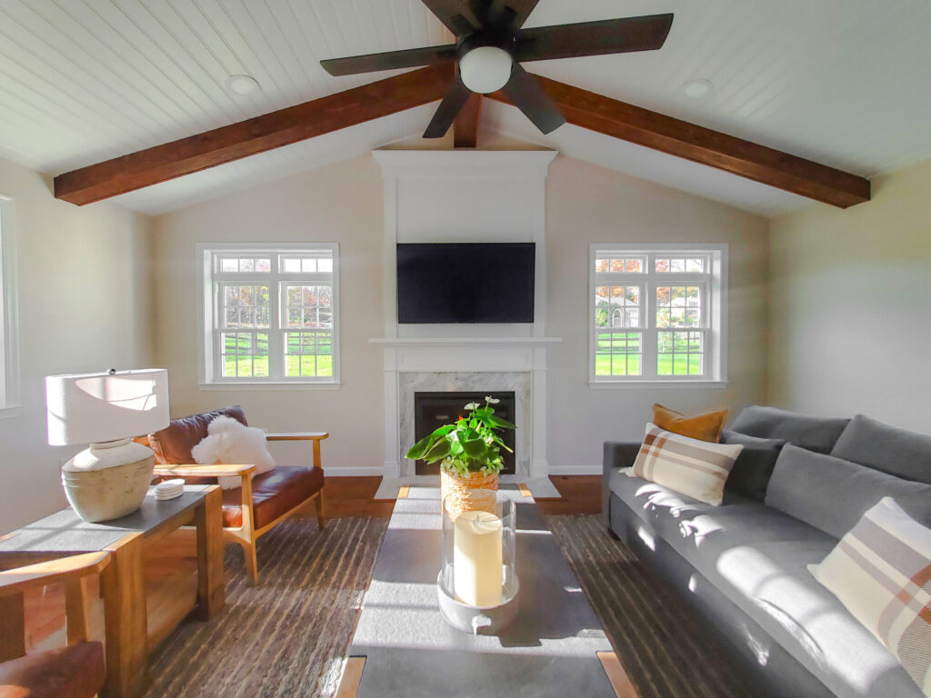 Traditional home addition with exposed beam, oversized ceiling fan and fireplace