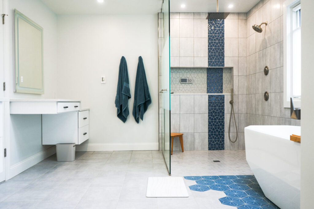 Modern walk-in shower with custom tile and a custom soaker tub